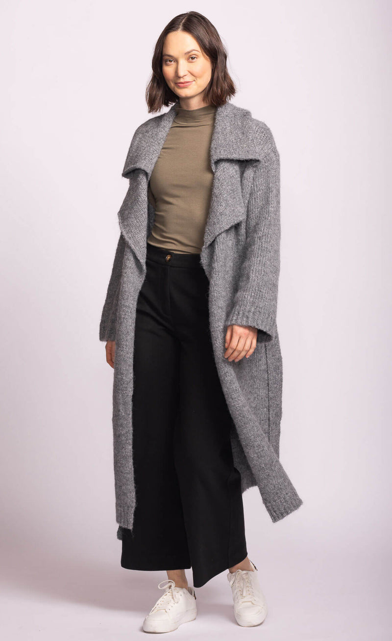 Martha Sweater in grey by Pink Martini, worn open over olive top and wide-leg pants, styled casually