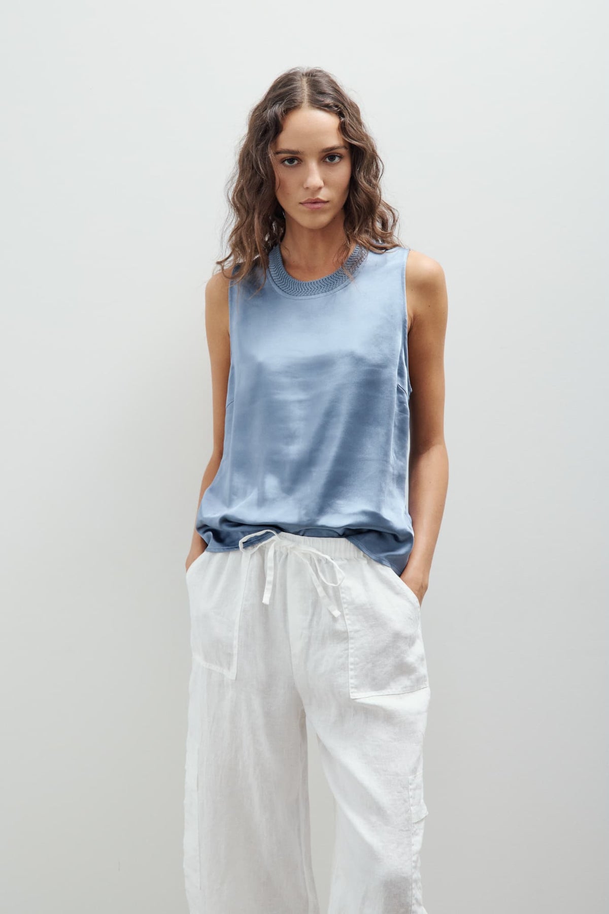 New York blue Melissa Nepton Kinsley top styled with light pants, sleeveless satin-look top with relaxed fit