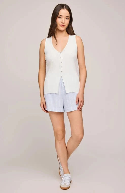 Model wearing the slim fit Miles tank by Gentle Fawn, paired with light blue shorts and sneakers.