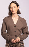 Close-up of the Monterey Sweater showing deep V-neckline, large tortoise buttons, and ribbed cuffs.