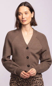 Close-up of the Monterey Sweater showing deep V-neckline, large tortoise buttons, and ribbed cuffs.