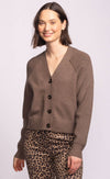 Model smiling in the Monterey Sweater, lightweight neutral taupe cardigan with button front and cropped silhouette.