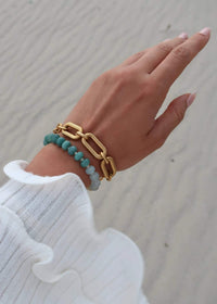 Namaste Jewellery Dania Bracelet Drift Pearl worn stacked beside a chunky gold chain bracelet with a white knit sleeve