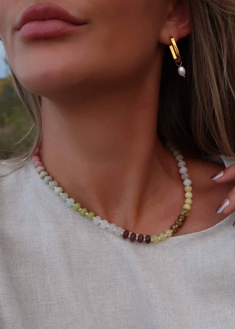 Model wearing Namaste Jewellery Dania Sunset Pop beaded necklace with soft pastel stone tones and gold earrings - Lemonberry Aurora