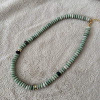 Namaste Jewellery Dania Stone Necklace in turquoise with soft green stone beads and gold accents on neutral fabric background - Lemonberry Aurora