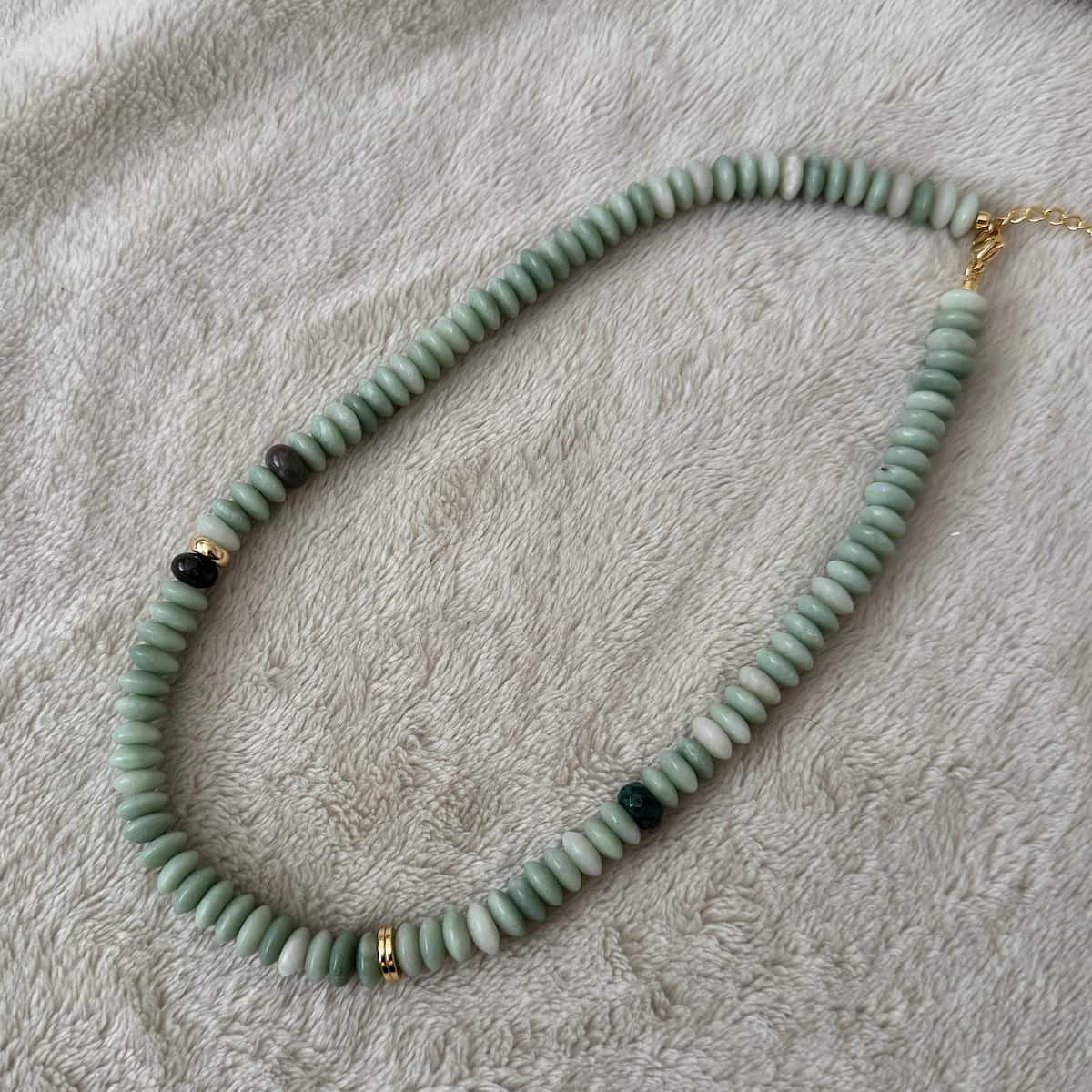 Namaste Jewellery Dania Stone Necklace in turquoise with soft green stone beads and gold accents on neutral fabric background - Lemonberry Aurora