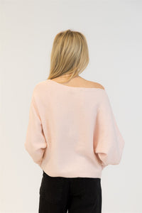 Back view of pale pink sequin knit sweater with subtle sparkle detail and loose fit.