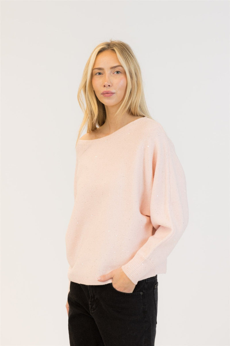 Side angle of pink sequin sweater showing boatneck and dropped shoulder styling.