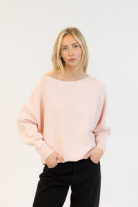 Woman wearing pale pink off-shoulder sparkle sweater with relaxed fit – front view, photographed at Lemonberry in Aurora, ON.