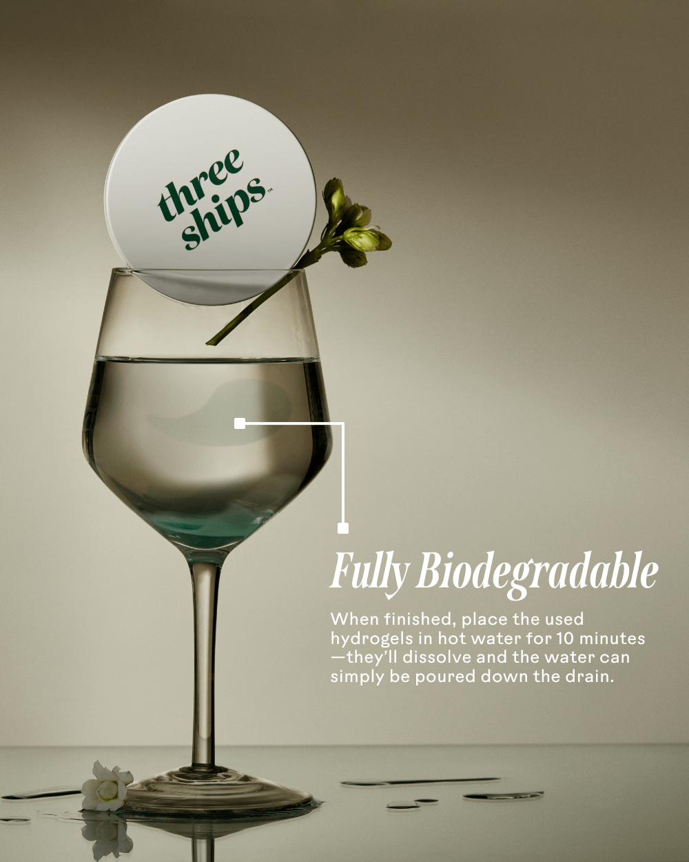Three Ships biodegradable eye mask dissolving in warm water, shown in wine glass