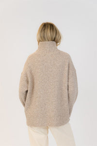 Back view of the Lyla & Luxe Oliver mockneck sweater showing relaxed fit and ribbed hem