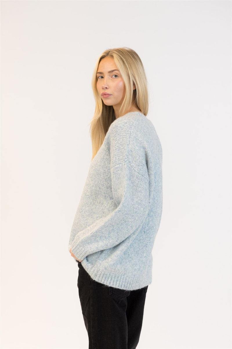 Relaxed profile in cozy crewneck sweater, soft blue marl tone