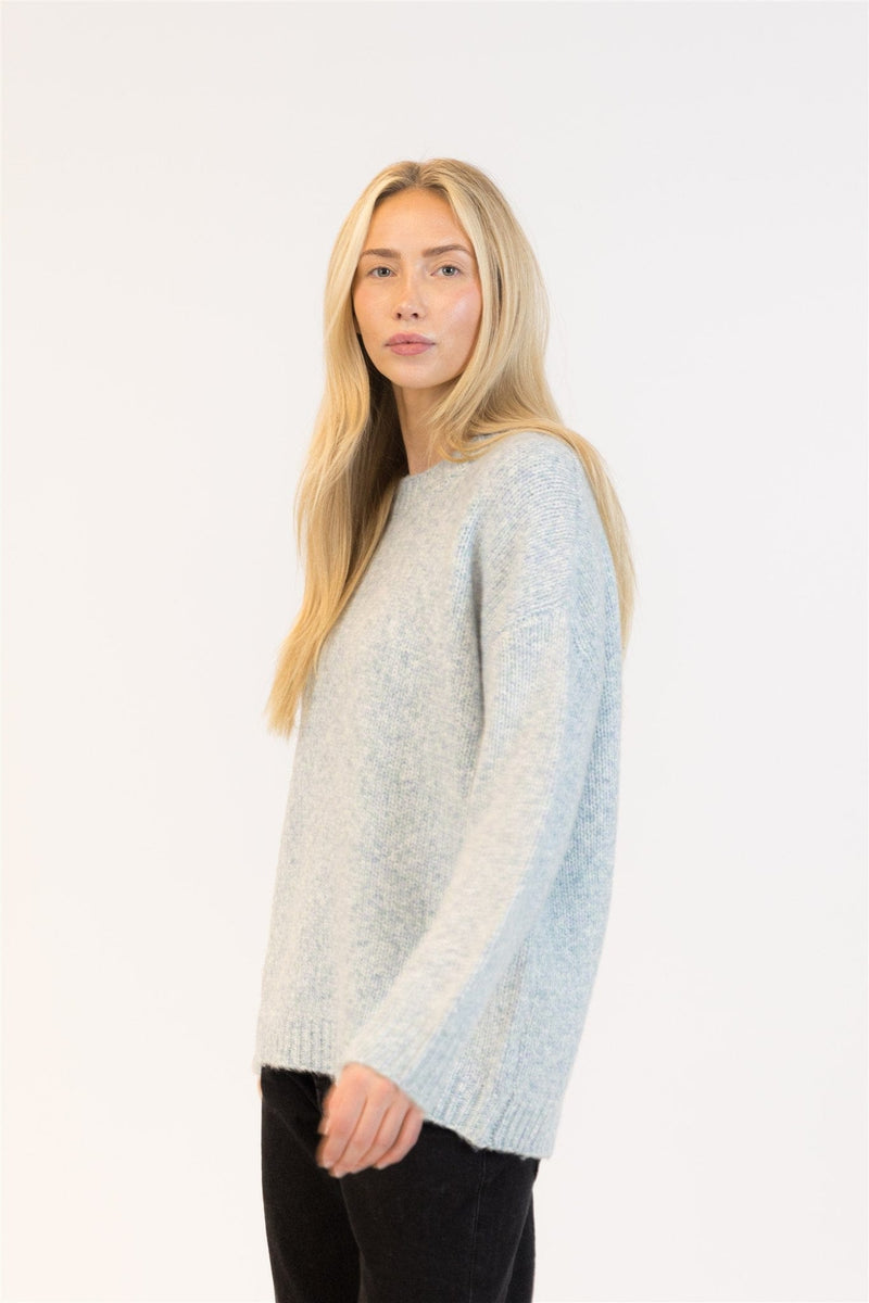 Side view of blue-green marl pullover with ribbed hem and cuffs

