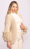 Close-up of Pink Martini Palermo Sweater in cream, highlighting voluminous looped sleeves and cozy knit – available at Lemonberry