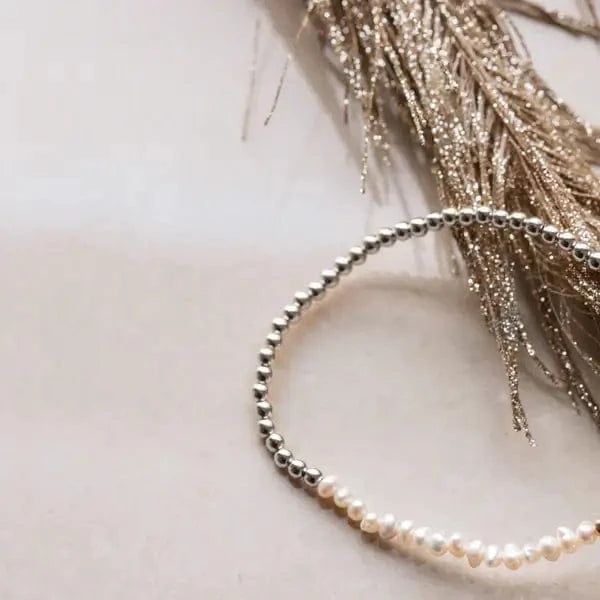 Silver and pearl intention bracelet with delicate shimmer background — flatlay at Lemonberry Boutique