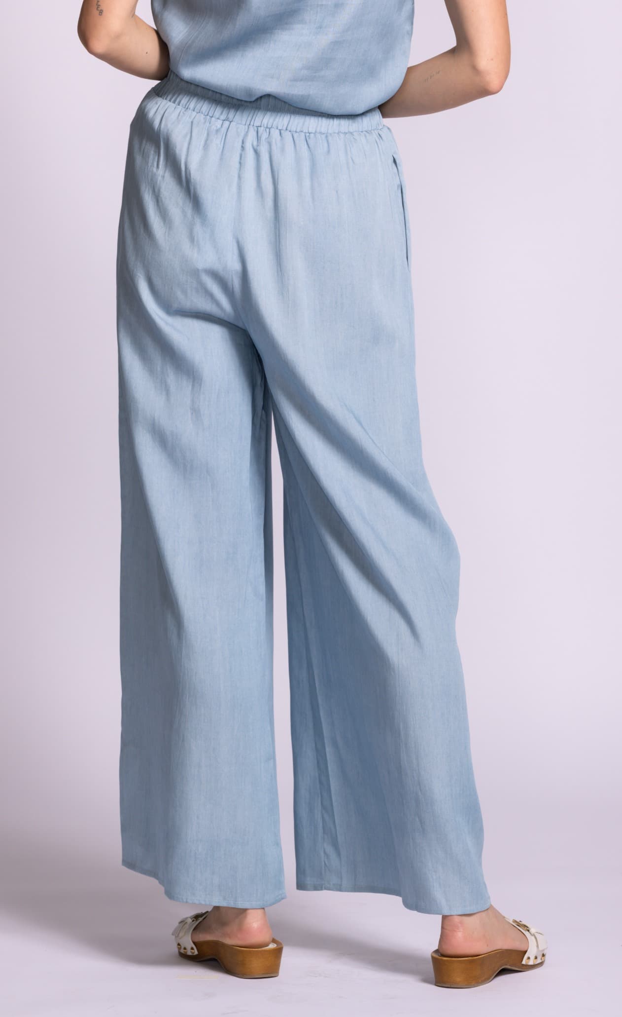 Back view of Pink Martini Dash blue wide-leg pants with soft drape at Lemonberry Aurora