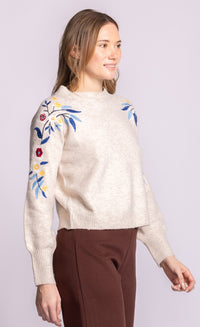 Pink Martini Holland sweater, angled-front view showing embroidered sleeve