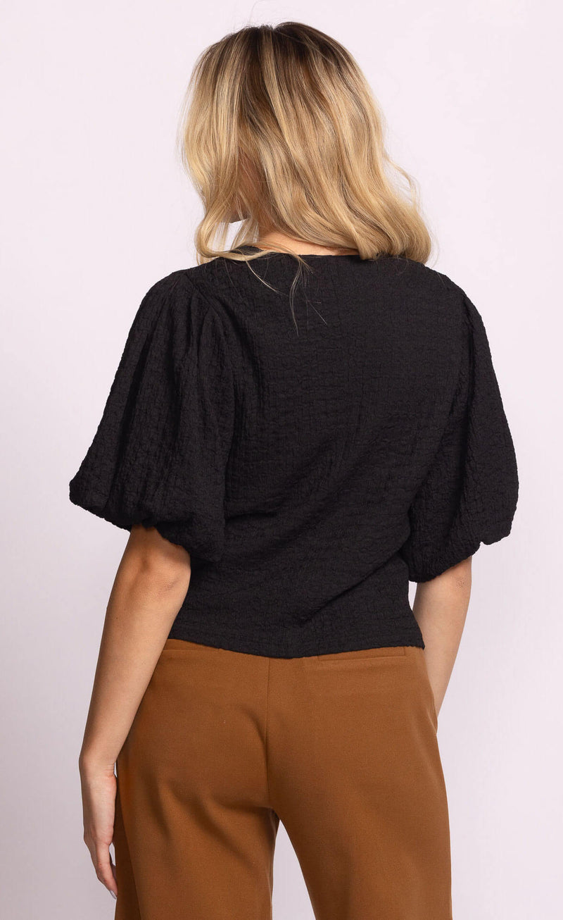Back view of Pink Martini Lita Top in black with puff sleeves.