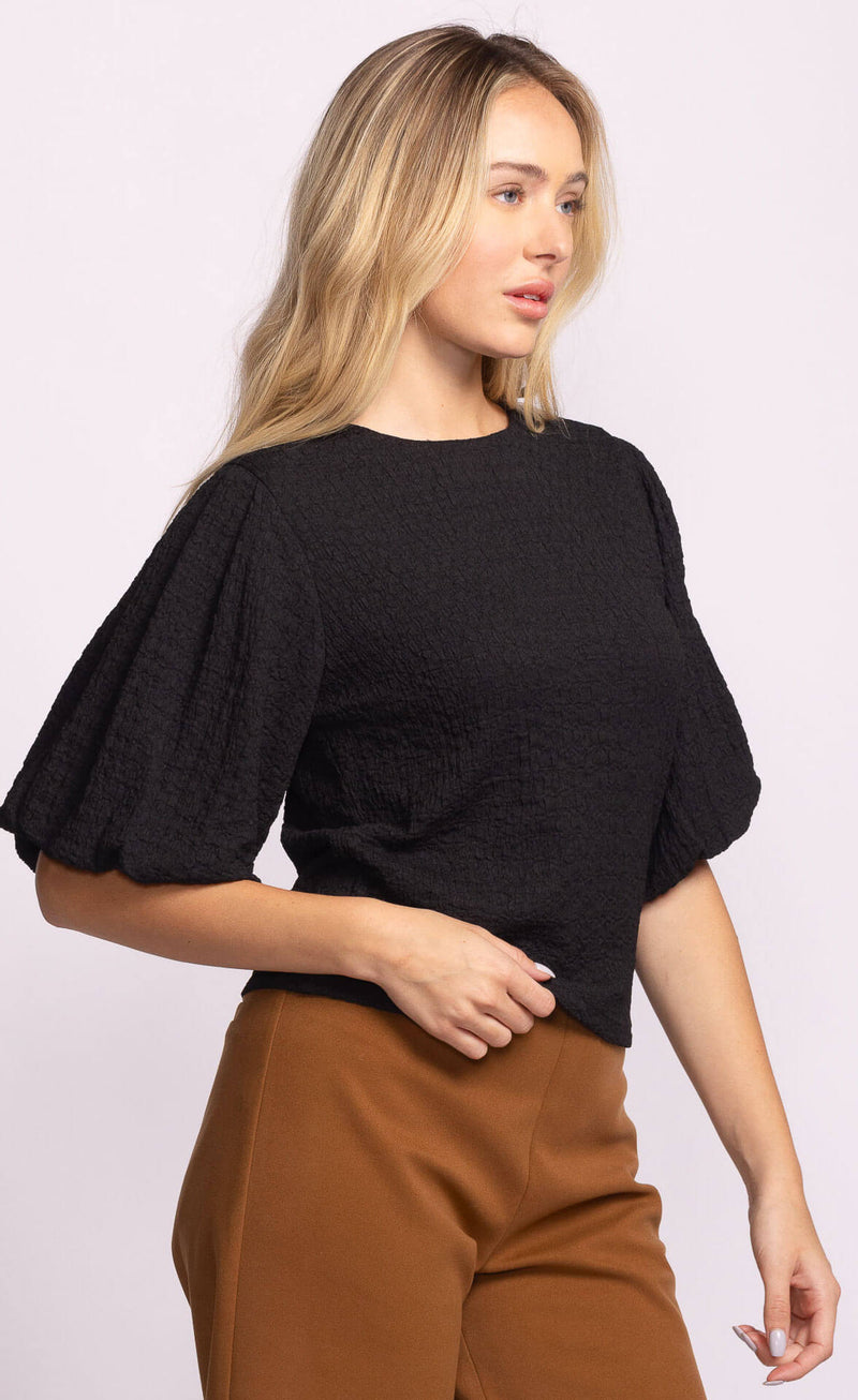Pink Martini Lita Top black with puff sleeves, side profile.