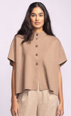 Front view of Pink Martini Melrose Sweater in tan, featuring stand collar and short sleeves, styled with beige trousers.