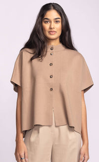 Front view of Pink Martini Melrose Sweater in tan, featuring stand collar and short sleeves, styled with beige trousers.