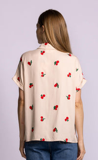 ack view of Pink Martini Mon Cherry blouse in beige with allover cherry embroidery.