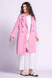 Pink Martini pink trench jacket styled with white pants and sandals — lightweight spring outerwear