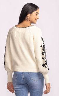 Back view of Pink Martini Pavia Sweater in cream with black floral embroidered statement sleeves – available at Lemonberry Toronto.