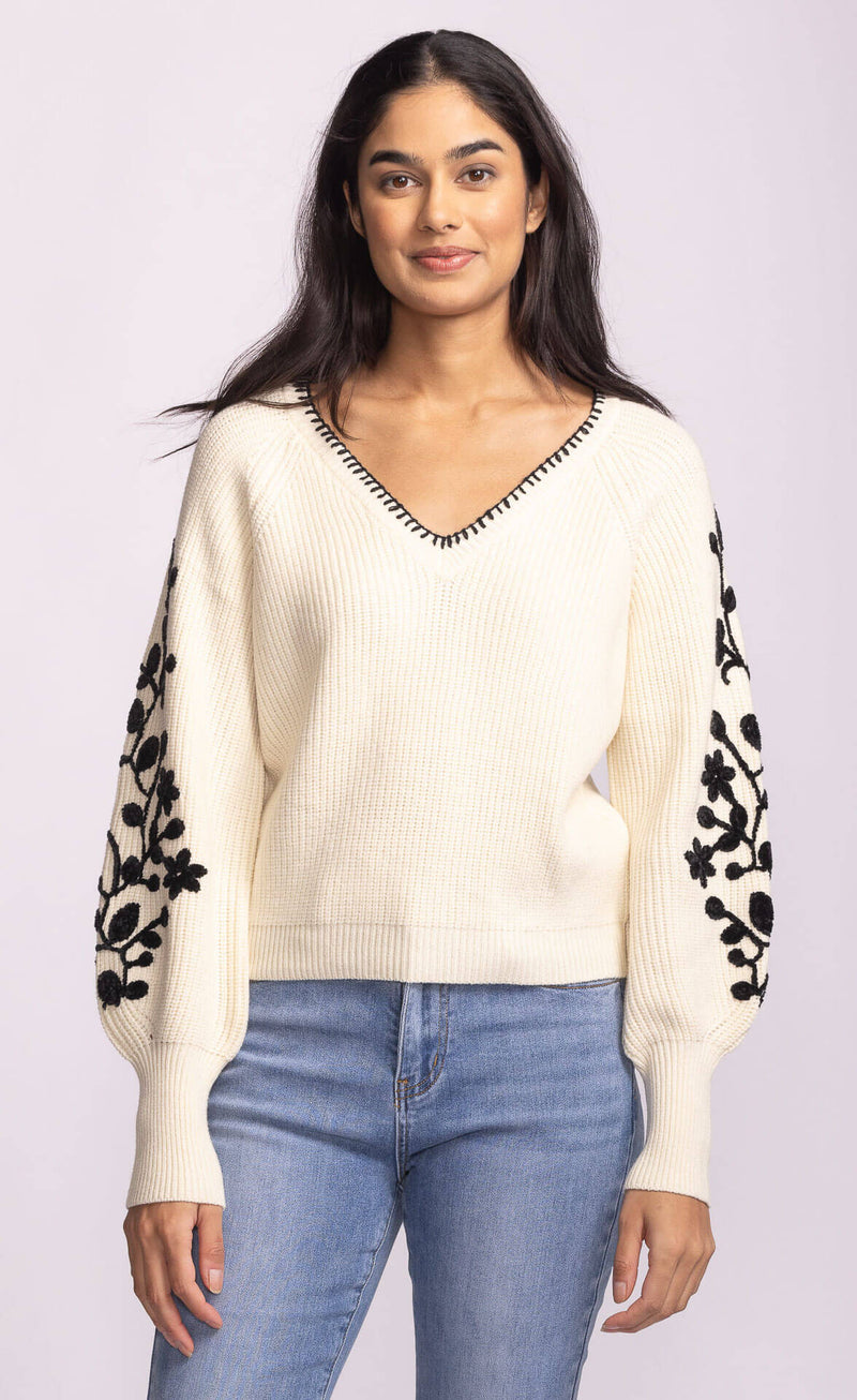 Back view of Pink Martini Pavia Sweater in cream with black floral embroidered statement sleeves – available at Lemonberry Toronto.