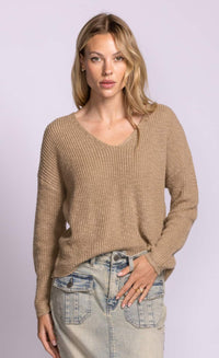 Pink Martini Sherri beige V-neck sweater styled half tucked into light wash denim.