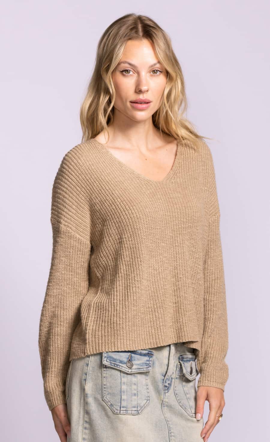 Pink Martini Sherri sweater in beige with V-neck and relaxed rib knit texture styled with light denim at Lemonberry Aurora.