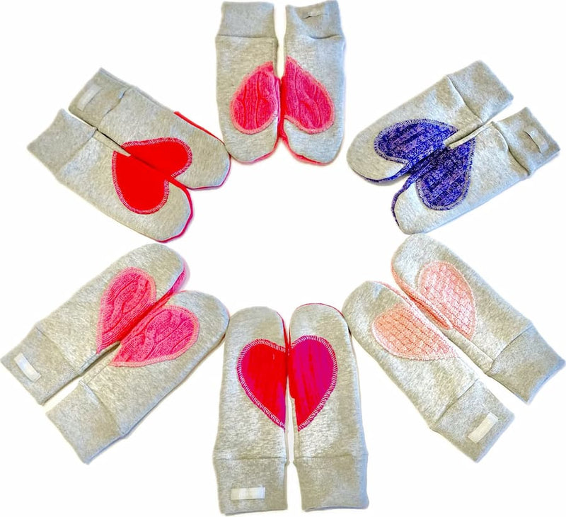 assorted grey fleece mitts with colourful upcycled wool heart patches Preloved Ariel Mitts Lemonberry Aurora flat lay