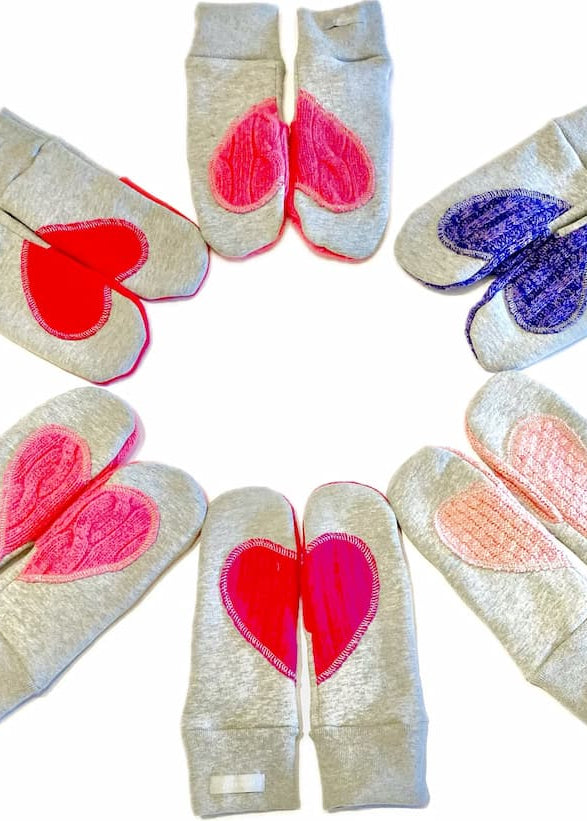 Preloved Ariel Mitts in assorted colours — Canadian-made fleece mittens with upcycled wool heart patches, photographed in a circle layout.