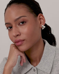 Model wearing silver heart button earrings by Jenny Bird — Lemonberry Aurora