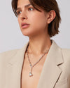 Woman wearing a Puffy Heart silver necklace by Jenny Bird against a neutral background