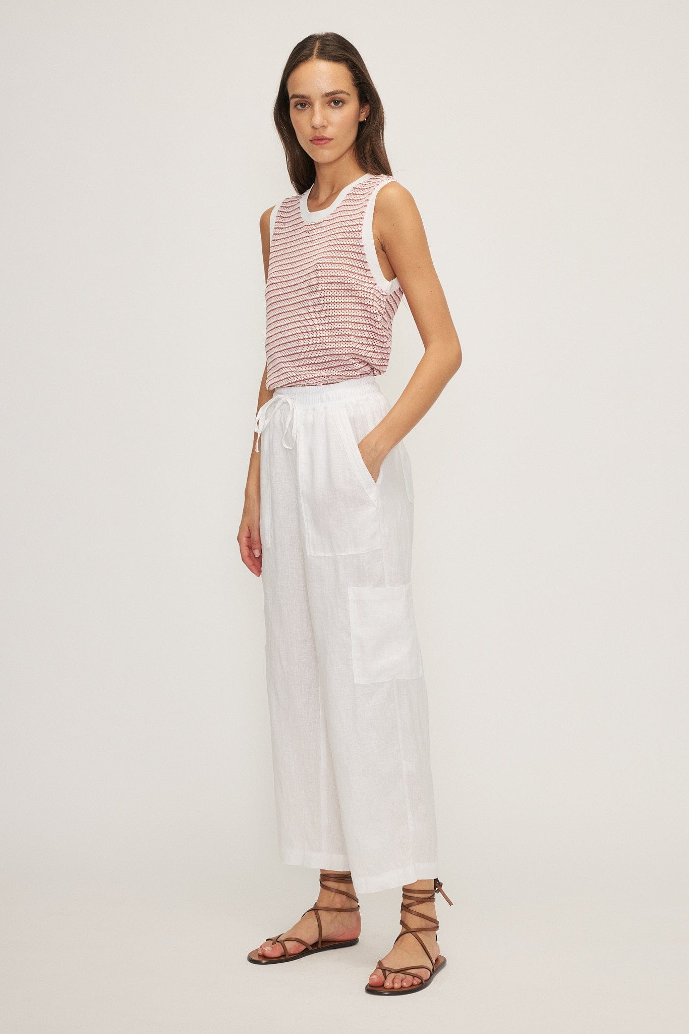 Angled view of Melissa Nepton Radison pants – linen wide leg pants with a tie waist and strappy sandals