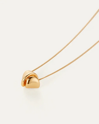 Folded metal detail on the Rio Pendant Necklace by Jenny Bird — high-polish gold finish available online at Lemonberry