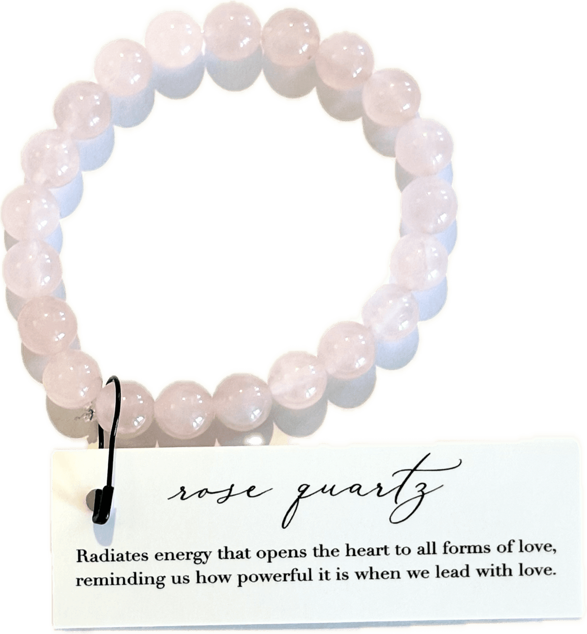 Rose quartz beaded bracelet with a descriptive card on a black background