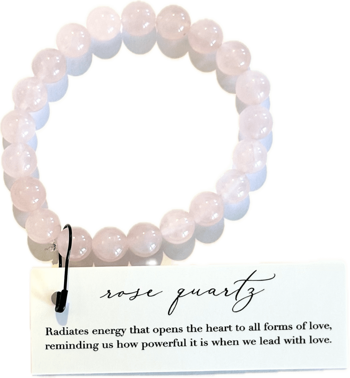 Rose quartz beaded bracelet with a descriptive card on a black background