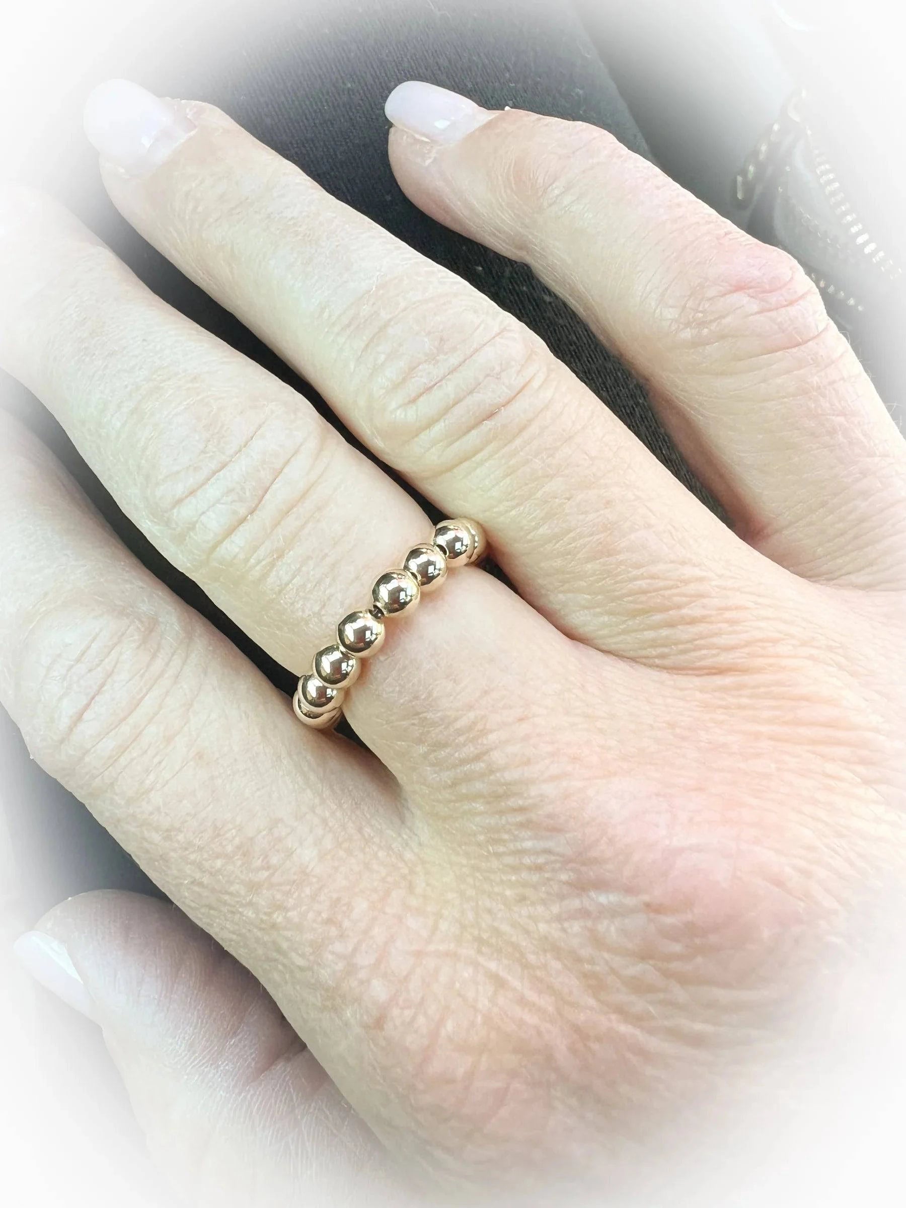 A Saskia De Vries 4mm 14K Gold-Filled Ring worn on a finger, showcasing its sleek, minimalist design and effortless, comfortable fit.