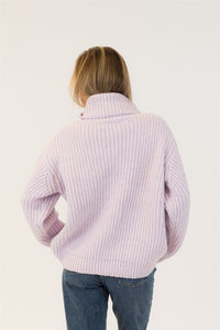 Back view of SAHAR sweater in lilac, ribbed texture and mockneck detail shown, styled with mid-rise denim