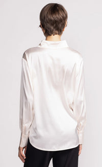 back view of ivory satin button-up shirt with long sleeves — Pink Martini, Lemonberry Aurora model