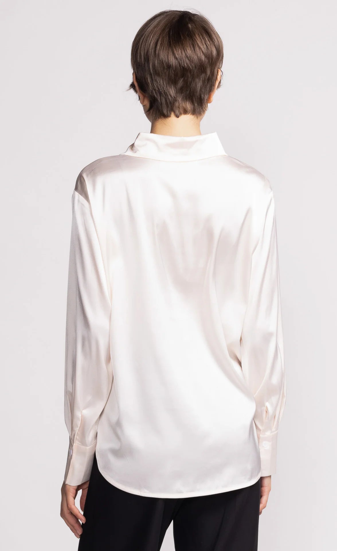 back view of ivory satin button-up shirt with long sleeves — Pink Martini, Lemonberry Aurora model