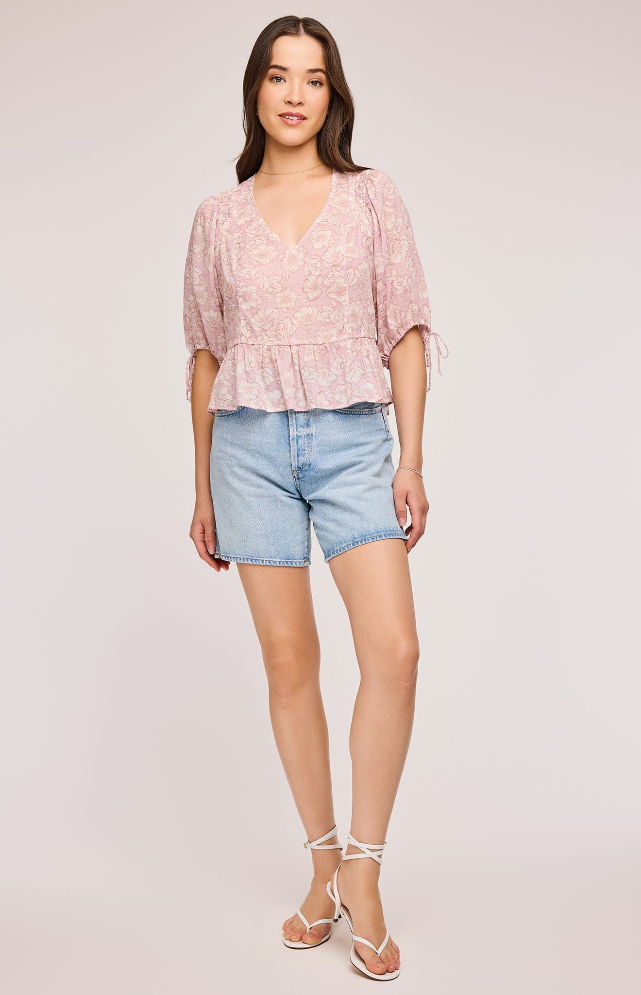 Front view of a model wearing the Serafina top by Gentle Fawn paired with denim shorts.