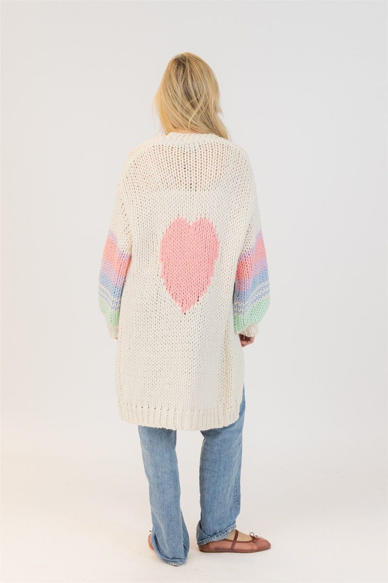 Full back view of model in Lyla + Luxe Shiloh cardigan showing large pink heart and pastel sleeves – clean studio background

