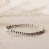 Sterling silver beaded bracelet on reflective surface — photographed at Lemonberry in Aurora, ON