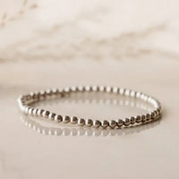 Sterling silver beaded bracelet on reflective surface — photographed at Lemonberry in Aurora, ON
