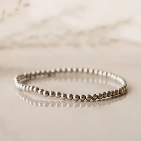 Sterling silver beaded bracelet on reflective surface — photographed at Lemonberry in Aurora, ON