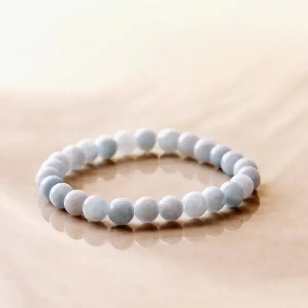 Aquamarine bead bracelet with soft blue stones resting on marble — available at Lemonberry in Aurora, ON