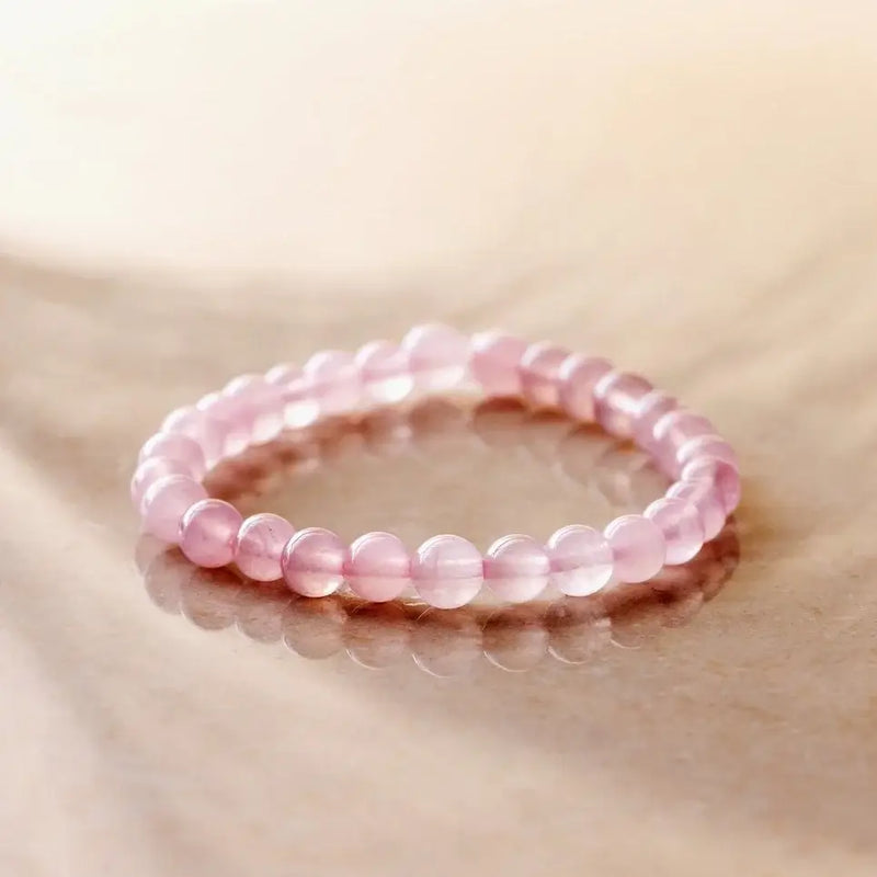 Rose quartz bracelet with soft pink beads on marble — available at Lemonberry in Aurora, ON